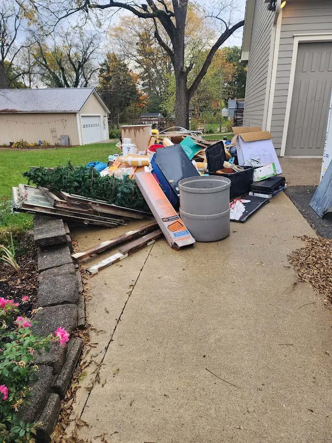 Dumpster being loaded with debris for Estate Cleanout Dumpster Rental in Moores Mill